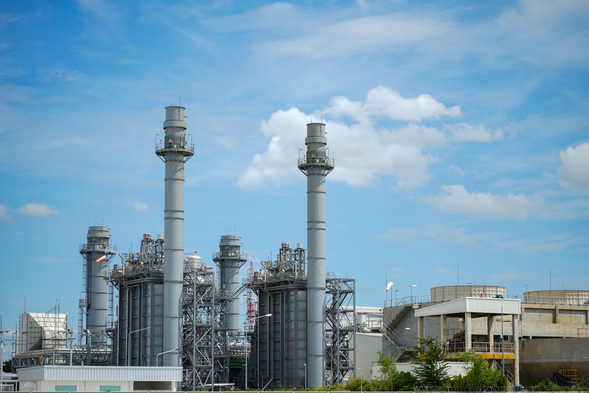 Power plant close up with blue sky background.